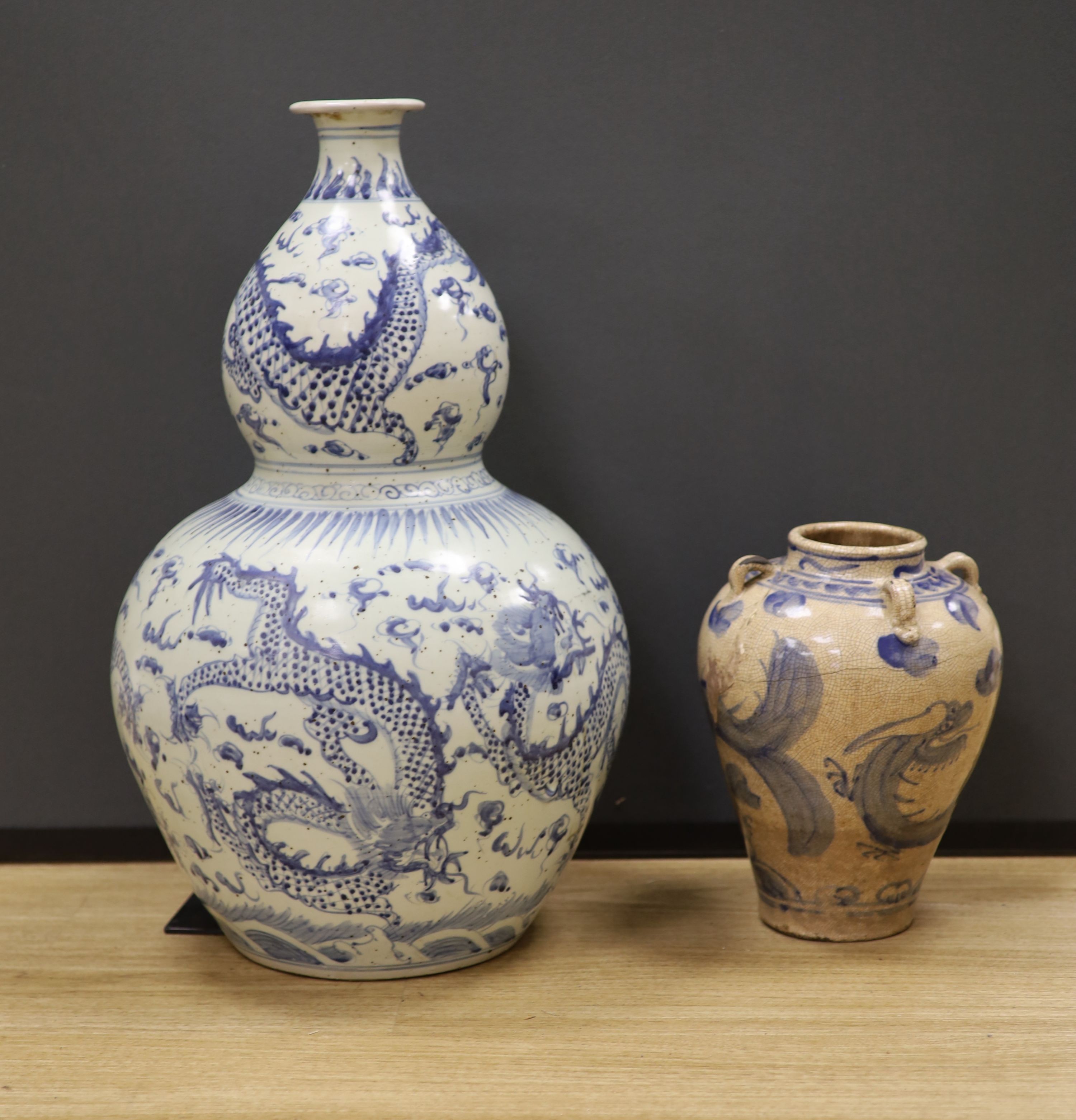 A large Chinese blue and white ‘dragon’ double gourd vase, 64cm high and an Annamese style blue and white crackle glaze jar